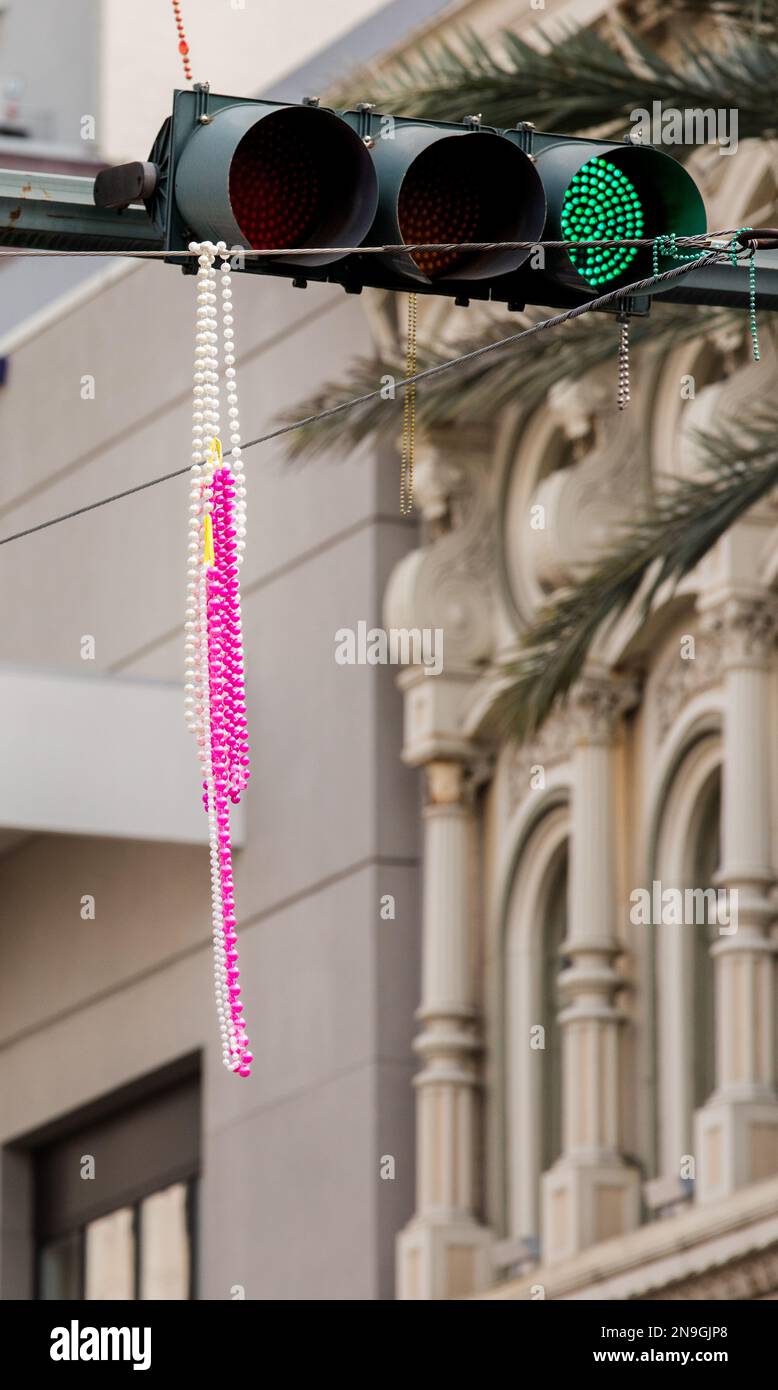 Dangling beads from stop light and city wires during Mardi Gras parade in New Orleans Stock Photo