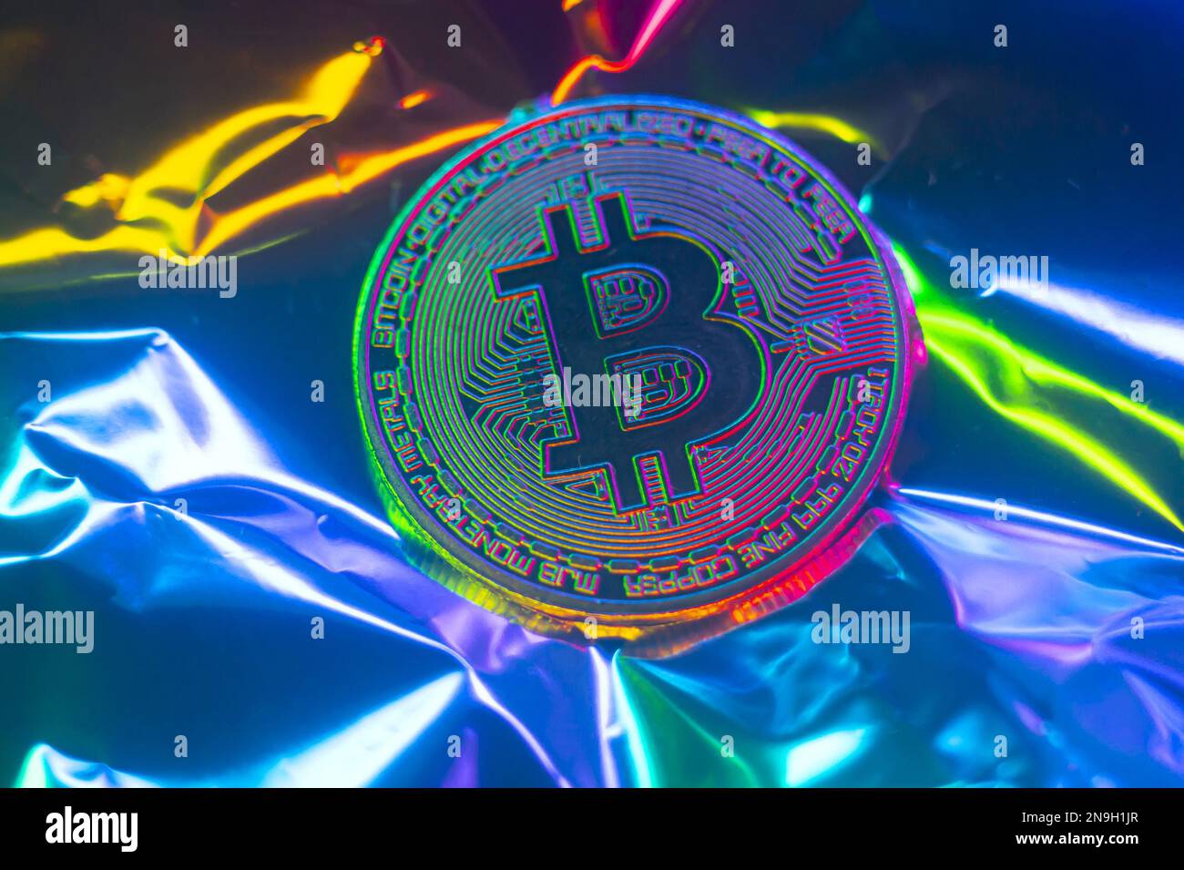 Crypto currency green-golden coin with bitcoin symbol on isolated on metallic background. Bitcoin Coin on black background. Bitcoin cryptocurrency. Cr Stock Photo