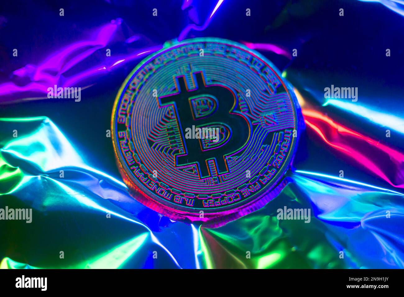Crypto currency green-golden coin with bitcoin symbol on isolated on metallic background. Bitcoin Coin on black background. Bitcoin cryptocurrency. Cr Stock Photo