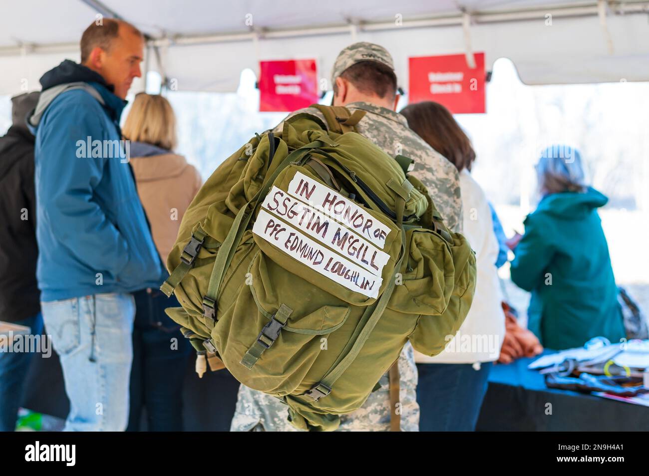 Soldier with names of the fallen written on ribbons on his rucksack to honor them during ToughRuck. Stock Photo