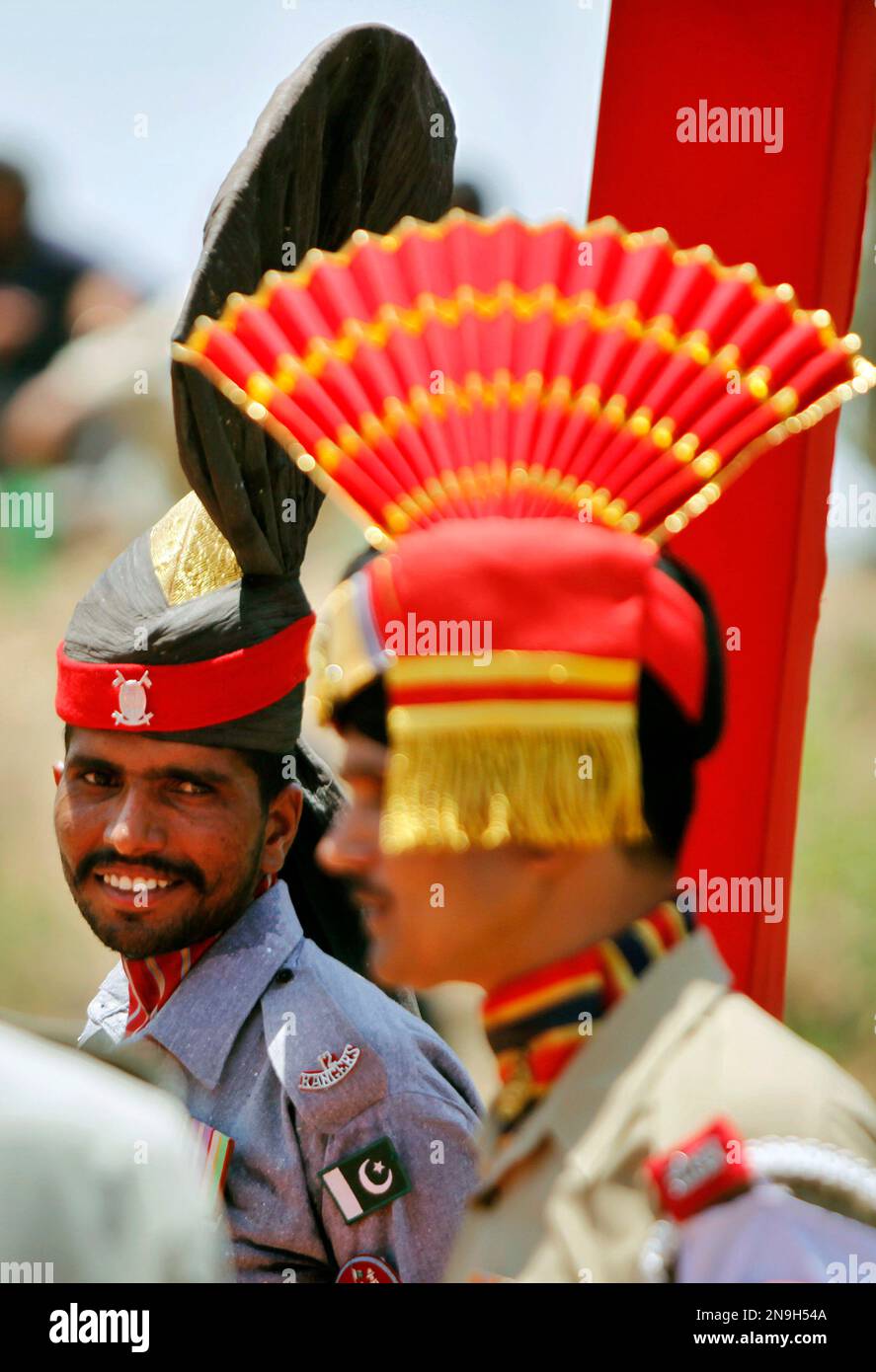 A Pakistani ranger stands near an Indian Border Security Force soldier ...