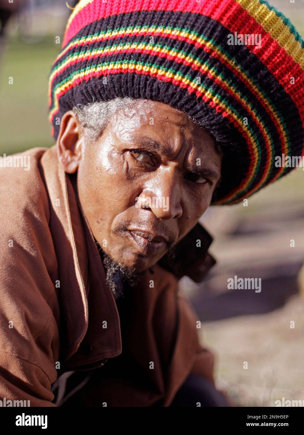 A man form the Khoisan ethnic group looks up during a poster unveiling ...