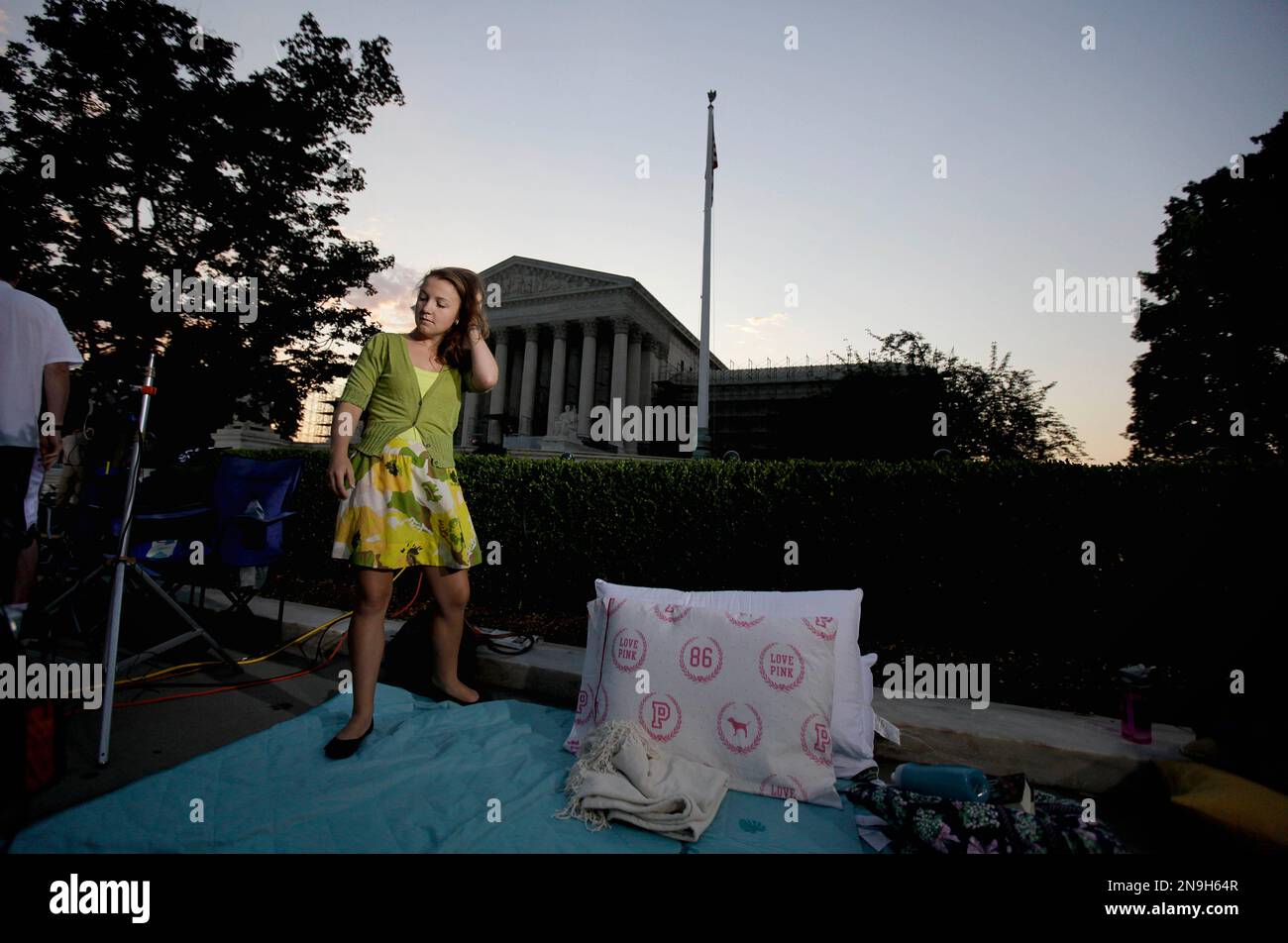Maggie O'Brien, 20, of Syracuse, N.Y., wakes up after spending the night  sleeping outside the Supreme Court Thursday, June 28, 2012, in Washington.  Saving its biggest case for last, the Supreme Court, image size:1300x952