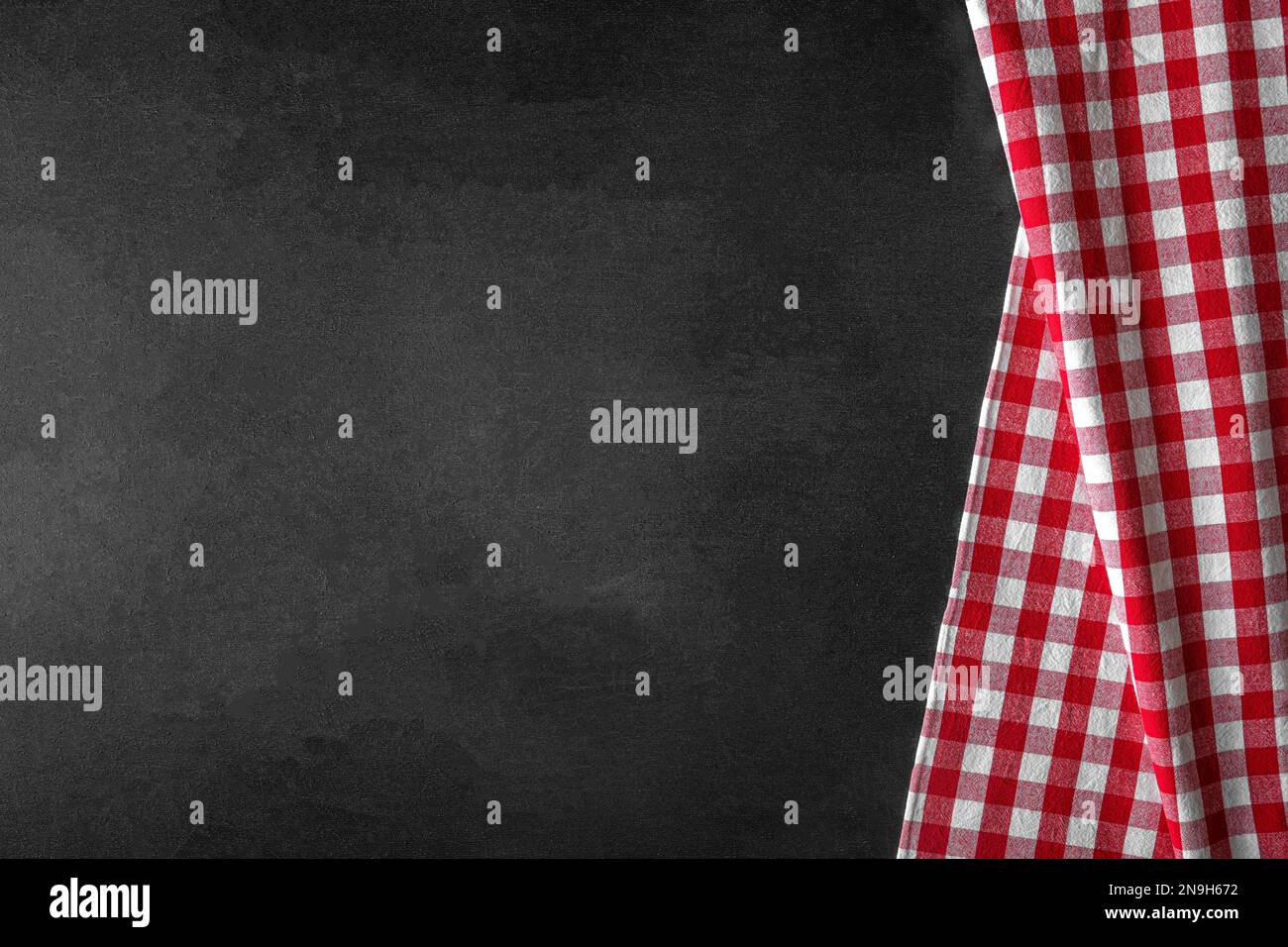 Checkered tablecloth on a black background. Stock Photo