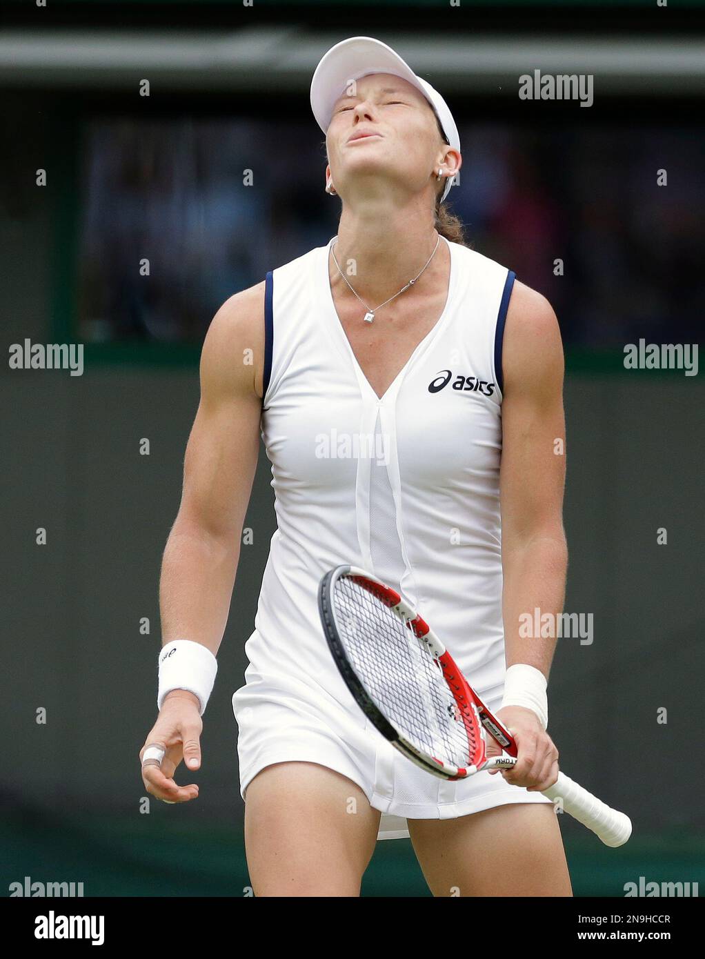 Samantha Stosur of Australia reacts during a second round women's singles  match against Arantxa Rus of Netherlands at the All England Lawn Tennis  Championships at Wimbledon, England, Wednesday, June 27, 2012. (AP