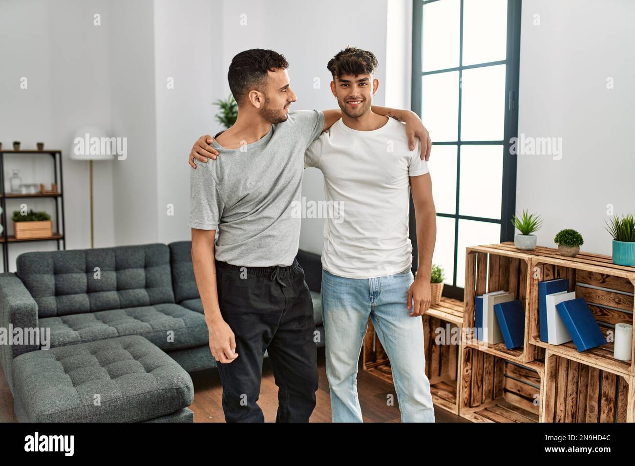 Two hispanic men couple smiling confident hugging each other at home ...