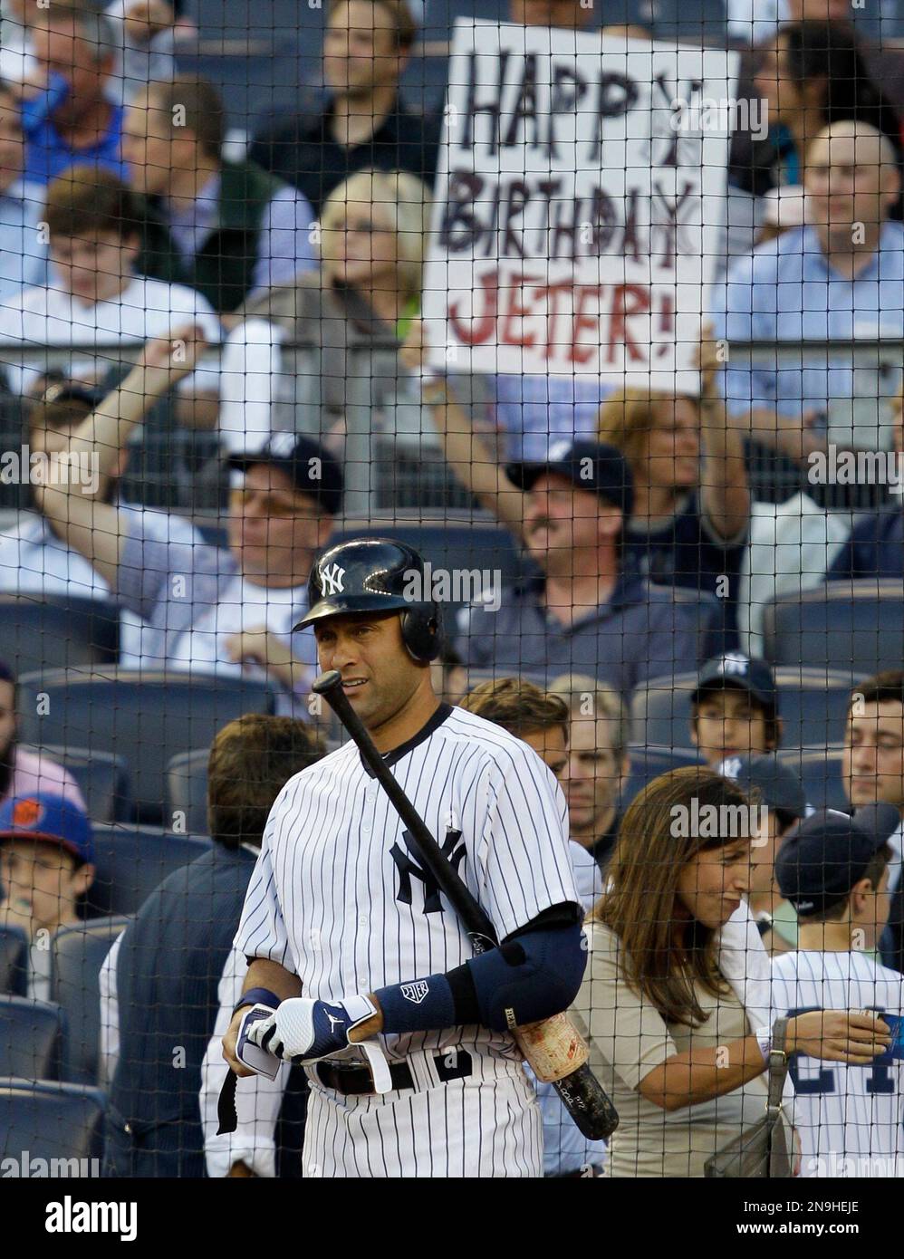 A fan holds a sign wishing New York Yankees on deck batter Derek