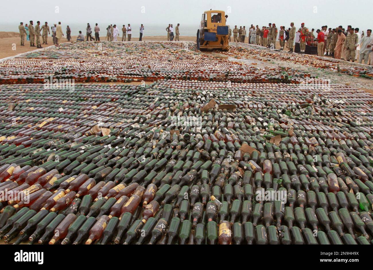 Pakistani security officers and members of the media, look at a steam