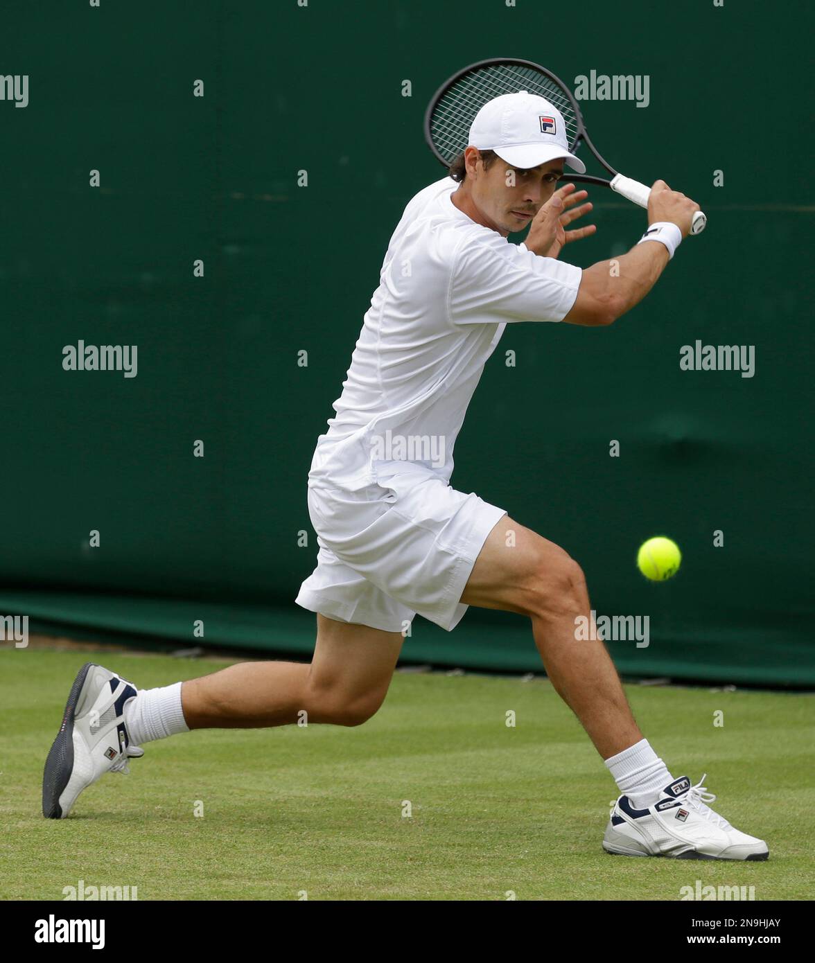 Igor Kunitsyn of Russia returns a shot against Go Soeda of Japan during a  first round men's singles match at the All England Lawn Tennis  Championships at Wimbledon, England, Tuesday, June 26,