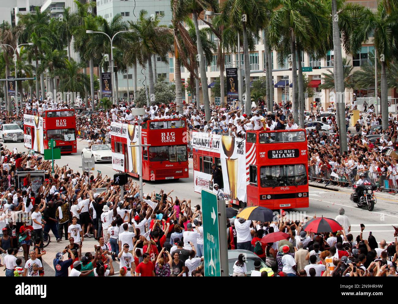 Miami Heat players ride in doubledecker buses during a parade in Miami