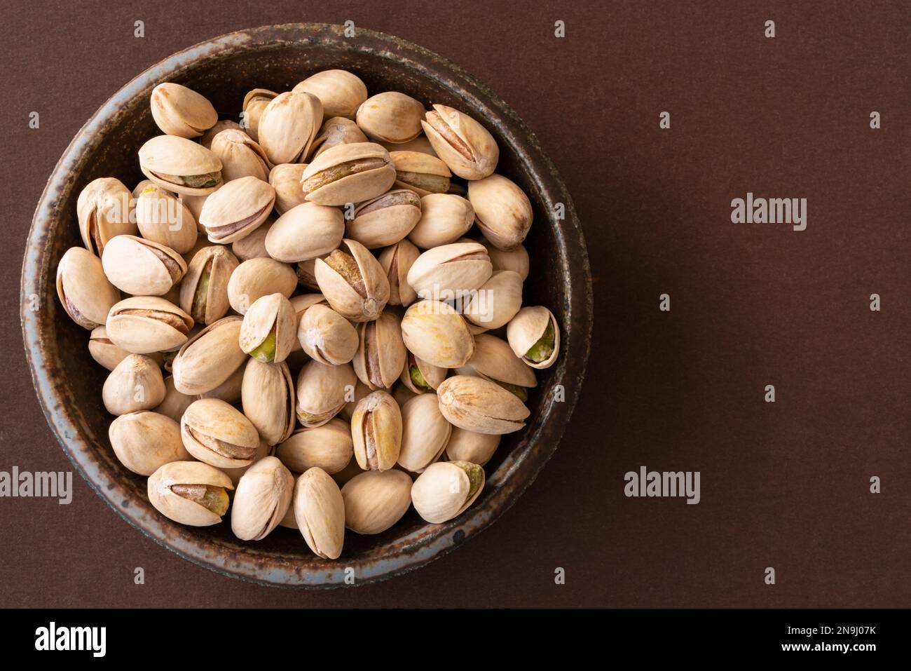 Roasted Salted Pistachios in a Bowl Stock Photo