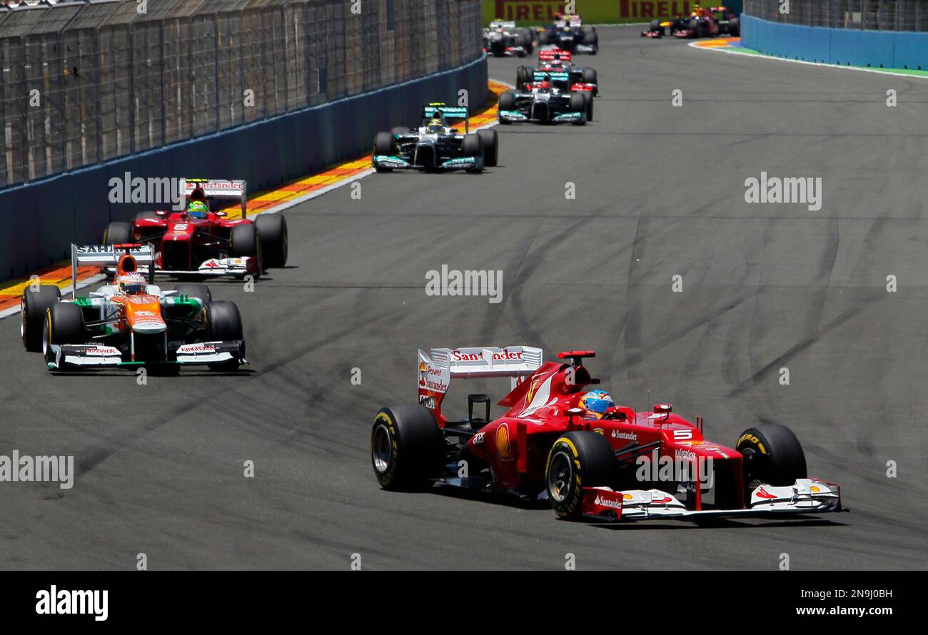 Ferrari's Fernando Alonso from Spain, right, drives his car in between the  pack during the European Formula One Grand Prix at Valencia street circuit,  Spain, Sunday, June 24, 2012. The race takes