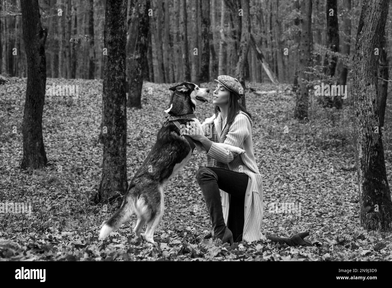 Woman playing dog in garden Black and White Stock Photos & Images - Alamy