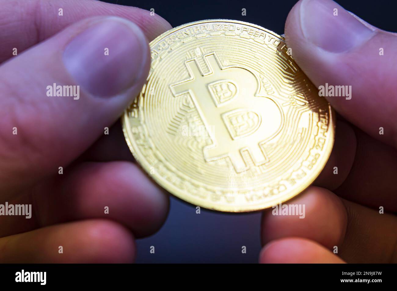 Bitcoin transfer concept from hand to hand. High quality photo. Finger hold  bitcoin golden on black isolated. Hand hold gold bitcoin crypto digital mo  Stock Photo - Alamy
