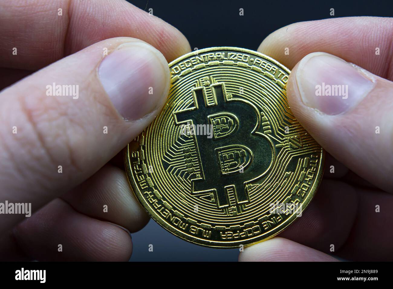 Bitcoin transfer concept from hand to hand. High quality photo. Finger hold  bitcoin golden on black isolated. Hand hold gold bitcoin crypto digital mo  Stock Photo - Alamy