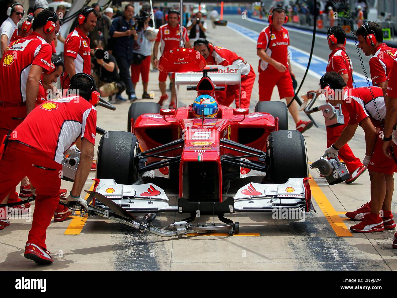 Ferrari's Fernando Alonso from Spain, right, drives his car in between the  pack during the European Formula One Grand Prix at Valencia street circuit,  Spain, Sunday, June 24, 2012. The race takes