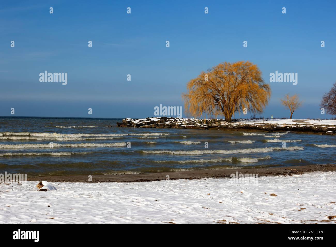 Sunlight emerges after a wintery storm dumps snow along the shores of Lake Erie at Edgewater Park in Cleveland, Ohio. Stock Photo