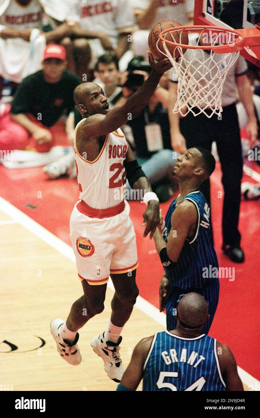 Houston Rockets guard Clyde Drexler (22) shoots for two points for two  points as he is defended by Orlando Magic center Shaquille O'Neal (32) and  guard Anfernee Hardaway, right, during the first