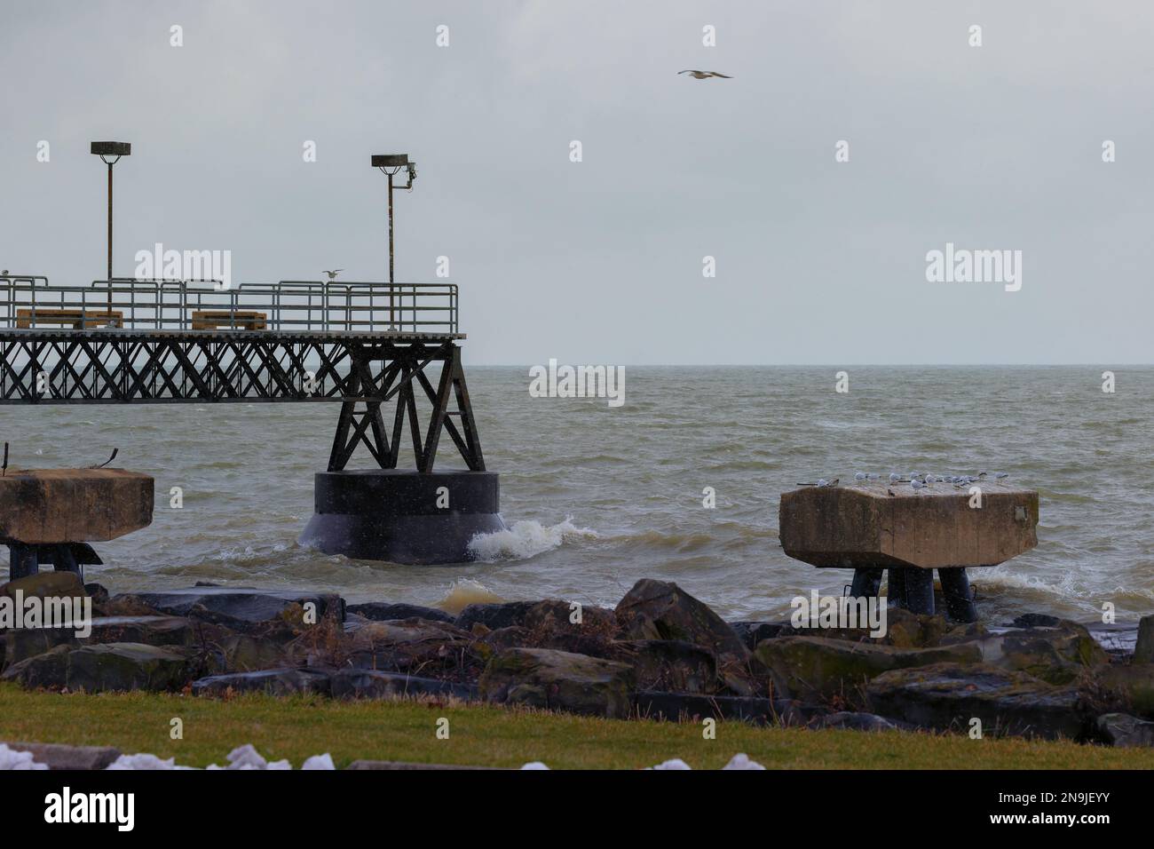 Lake effect snow flurries on a cold and stormy day along the shores of ...