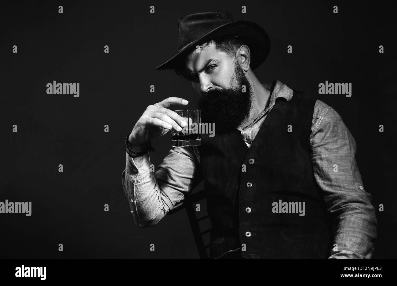 Drunk man holding whisky glass after he drank a lot of alcohol and