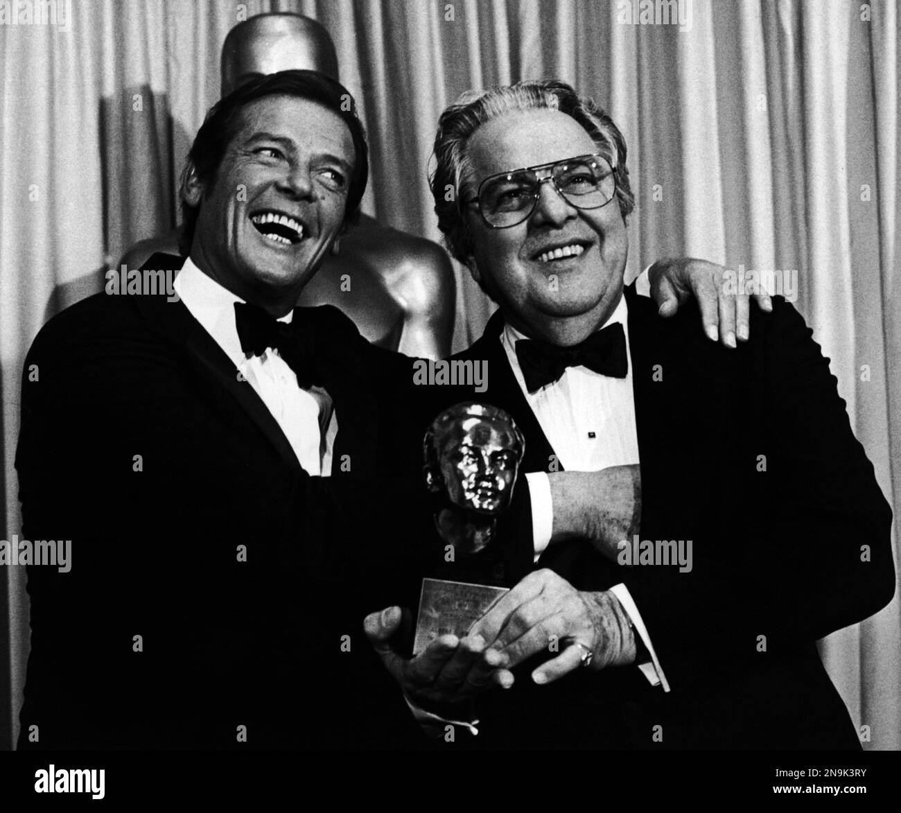 Actor Roger Moore, left, stands with Albert Broccoli, known as Cubby ...