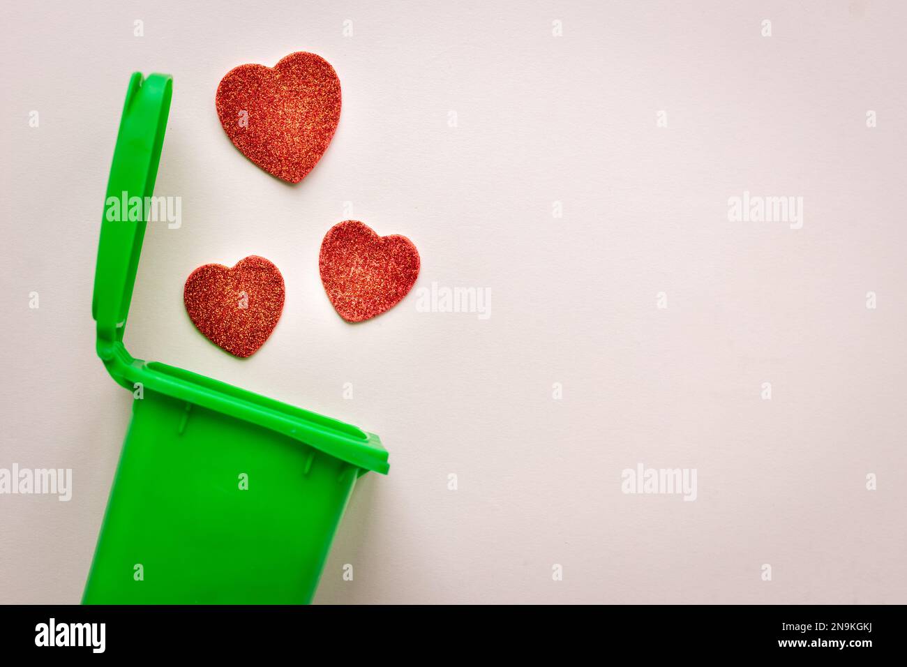 The end of love, anti-valentine's day,heartbreak concept, hearts falling into the garbage can Stock Photo
