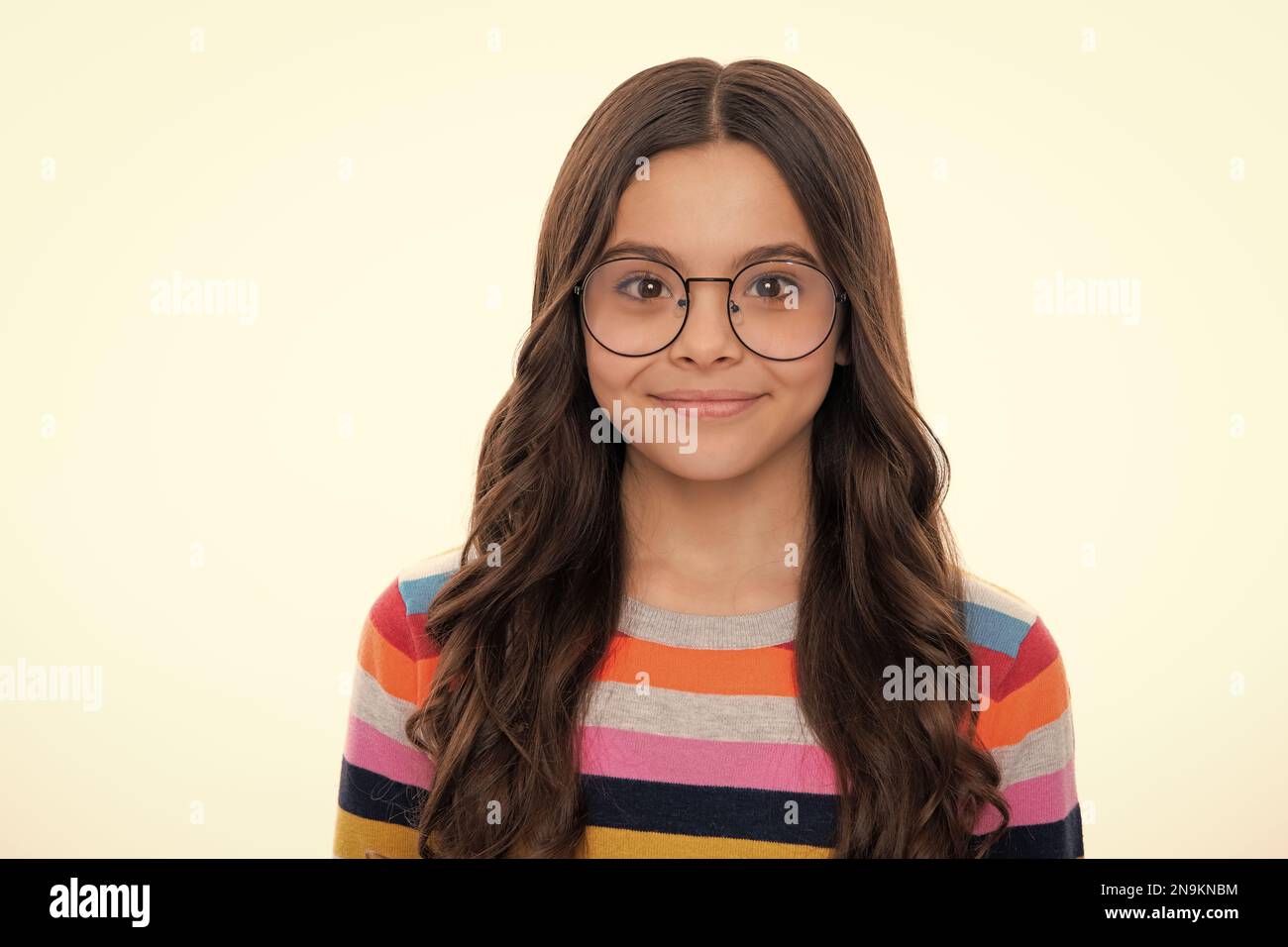 Portrait of beautiful happy smiling teenage girl on yellow studio ...