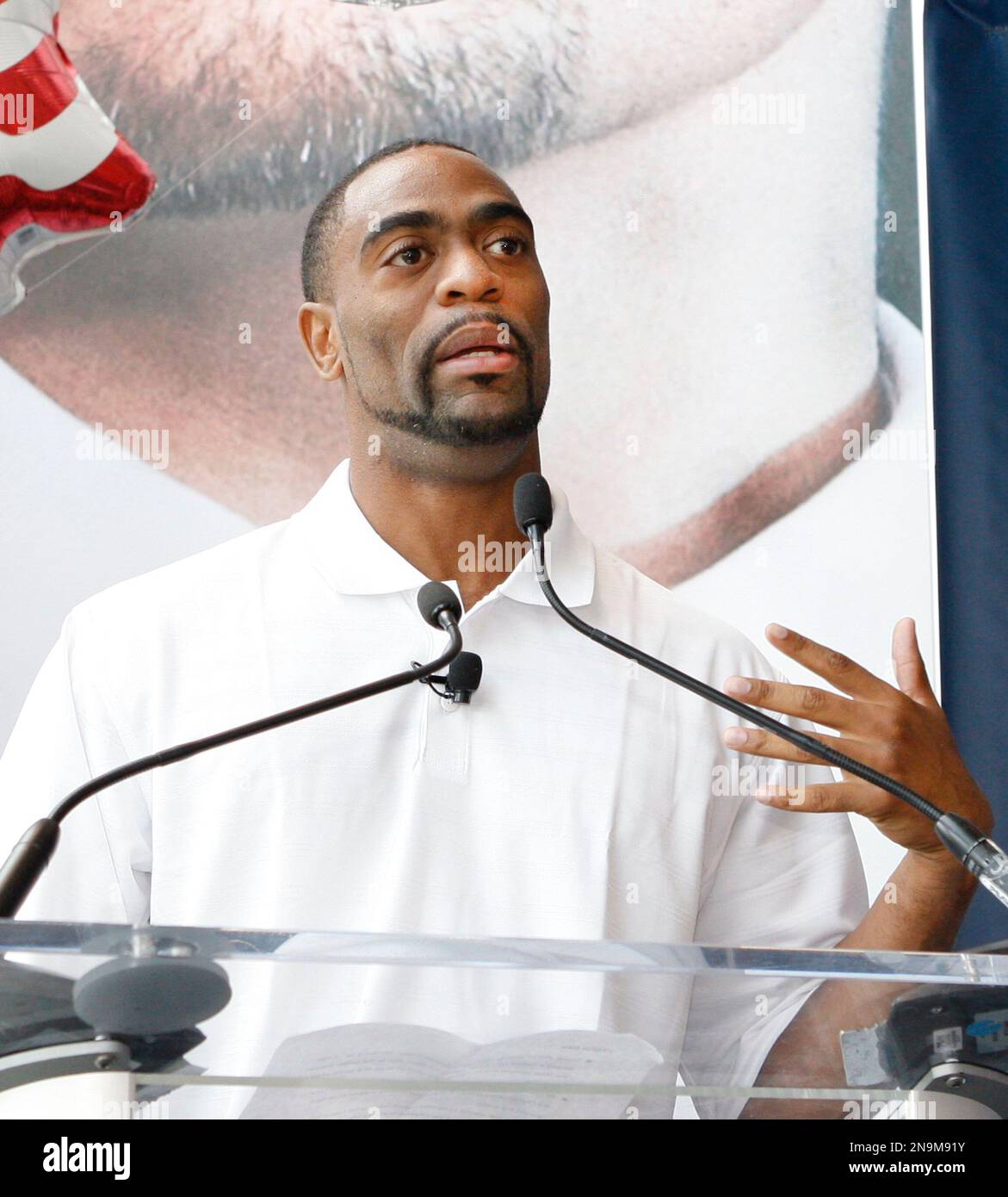 American 100m record holder Tyson Gay speaks prior to presenting 