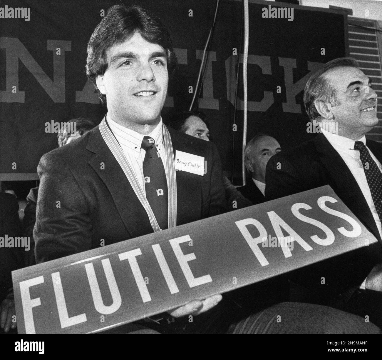 Heisman Trophy winner Doug Flutie holds up a street sign created for