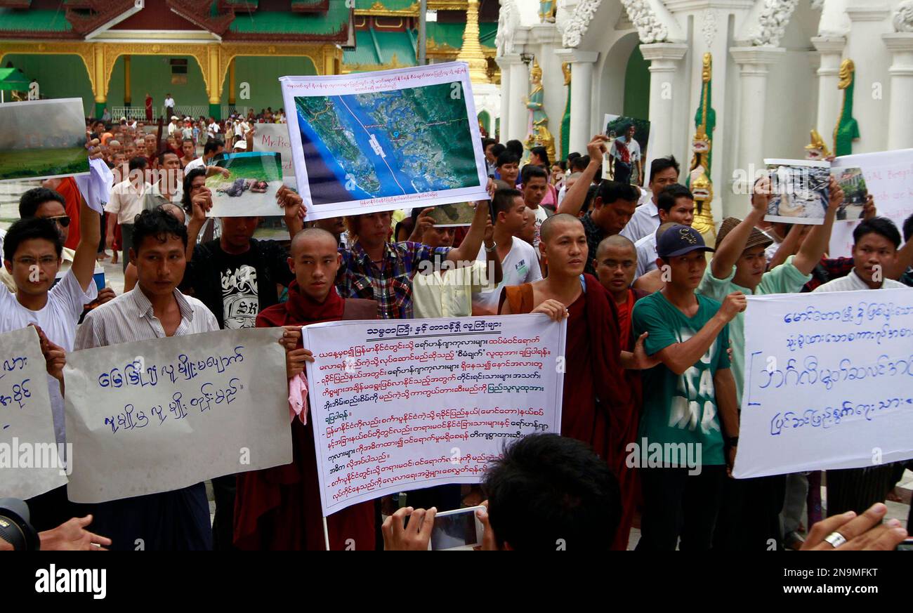 Buddhist monks and ethnic Rakhine people hold placards at Shwedagon pagoda in Yangon, Myanmar