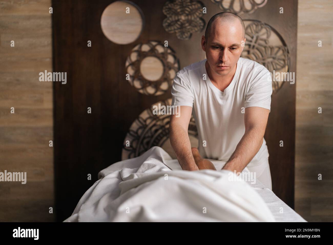 Portrait of professional male masseur performing lymphatic drainage