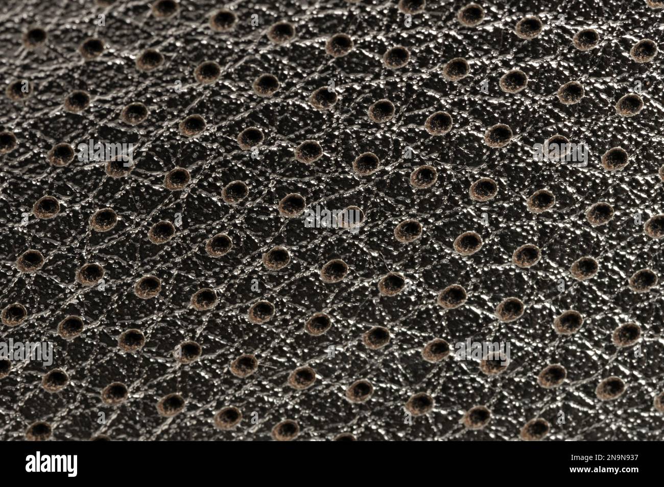 Shiny perforated grid background macro close up view Stock Photo