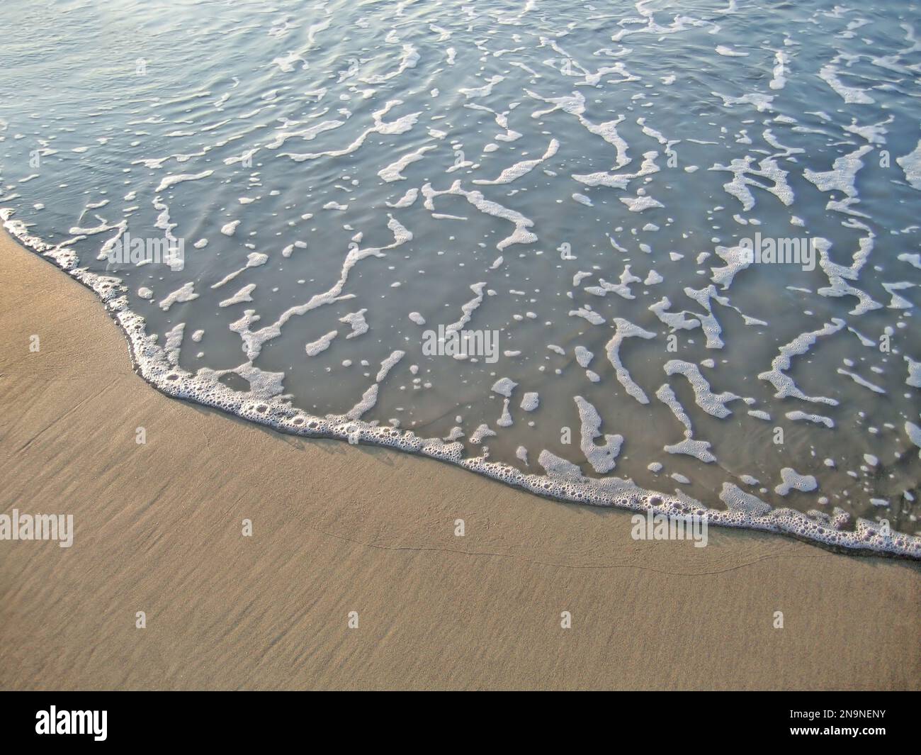 Sea wave on sand background, natural texture Stock Photo