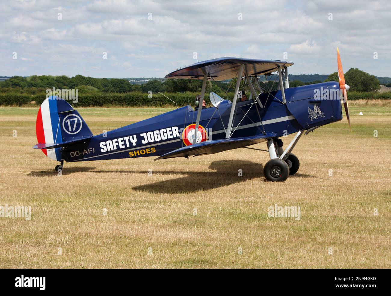 A SNCAN/Stampe SV.4C biplane advertising Safety Jogger shoes at Headcorn airfield Kent England Stock Photo