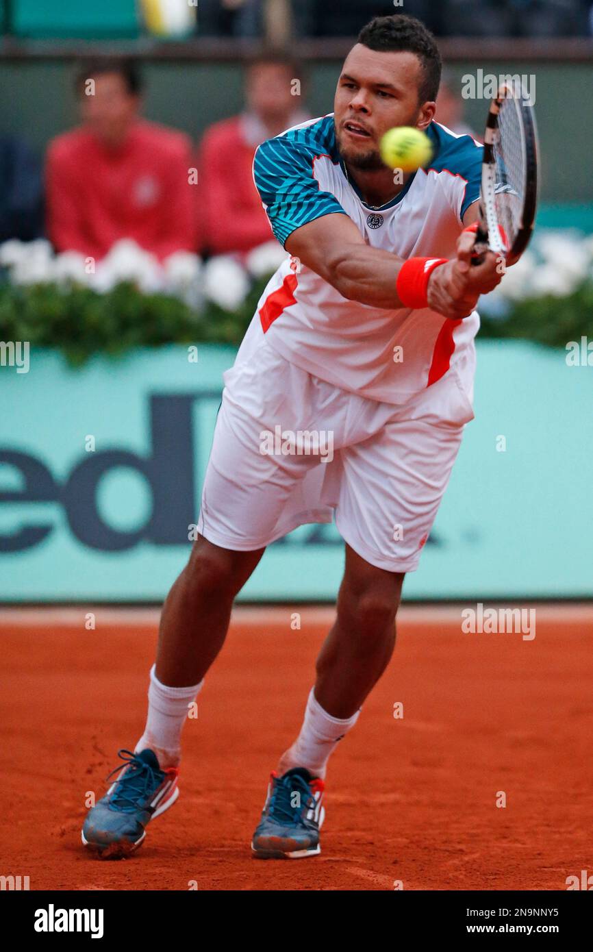 Jo-Wilfied Tsonga of France returns in the fifth set of his fourth round  match against Stanislas Wawrinka of Switzerland at the French Open tennis  tournament in Roland Garros stadium in Paris, Sunday