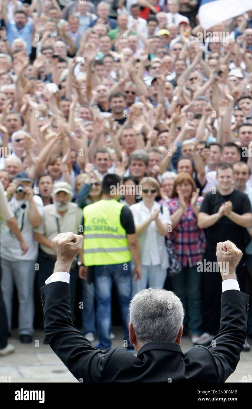 Serbian President Tomislav Nikolic, front, faces a crowd of well ...