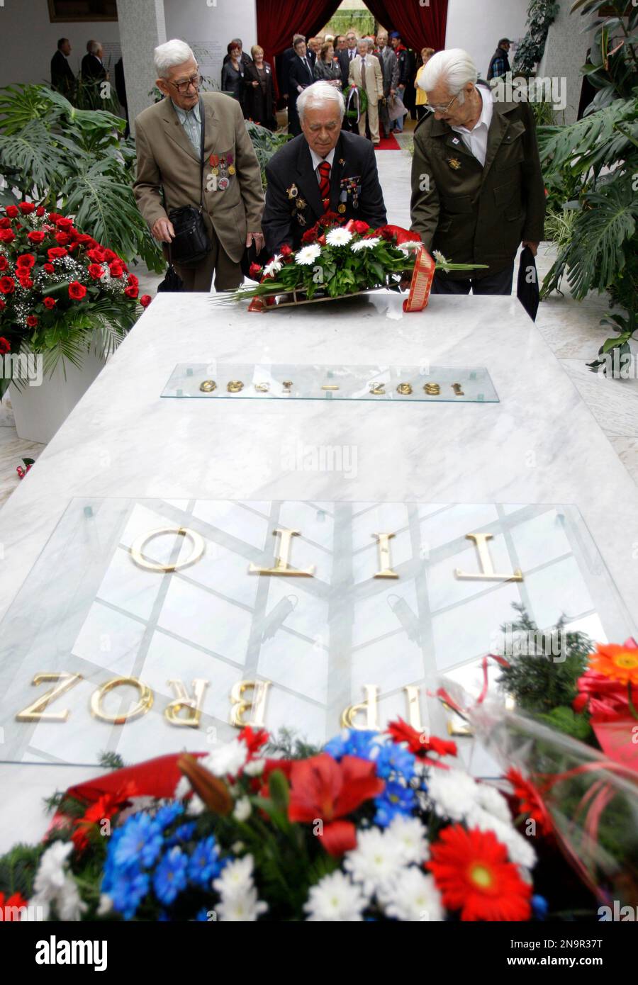 Supporters of former Yugoslav President Josip Broz Tito stand by his ...