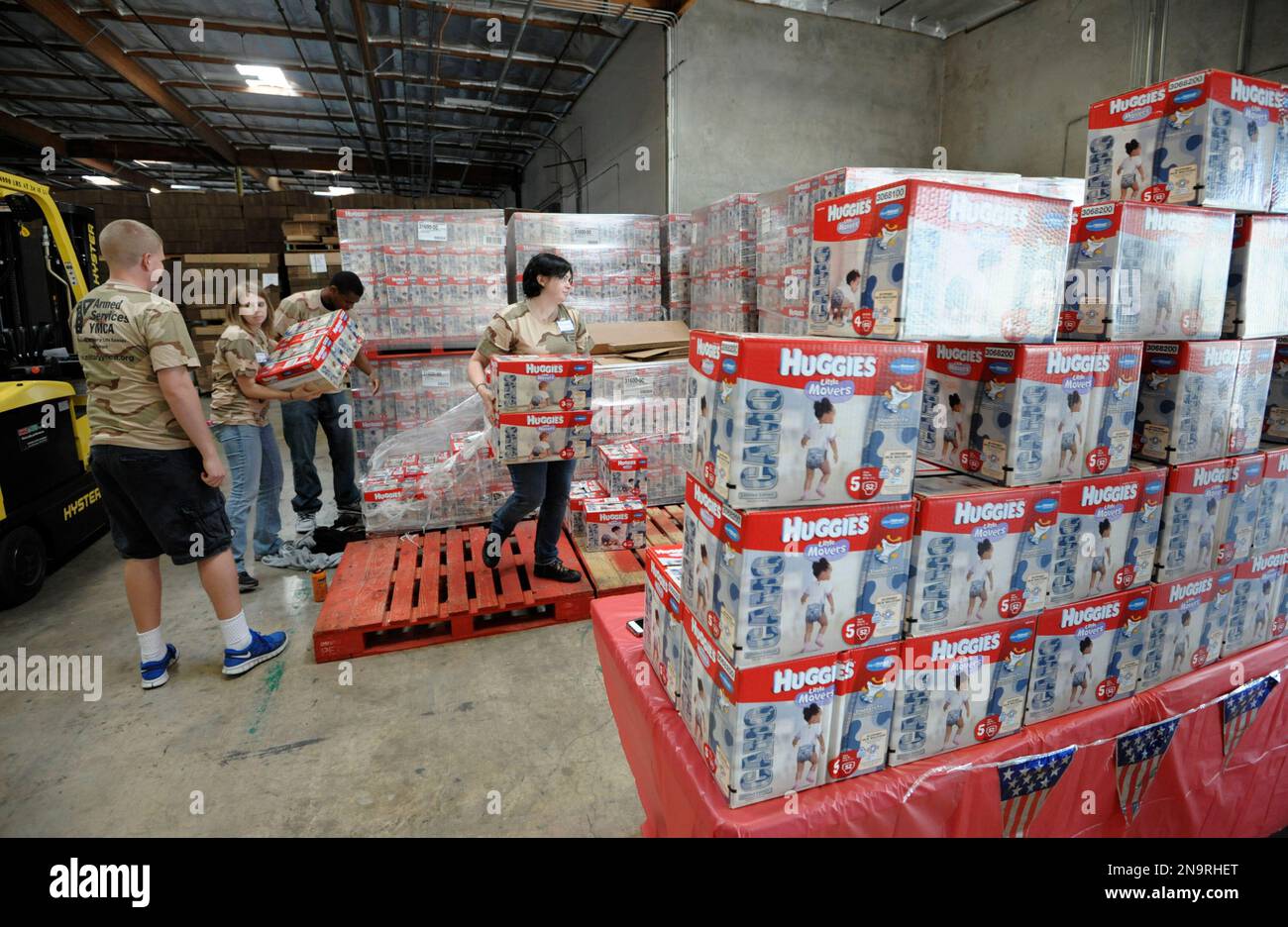 Volunteers unload boxes of Huggies Camo Diapers at the San Diego Food