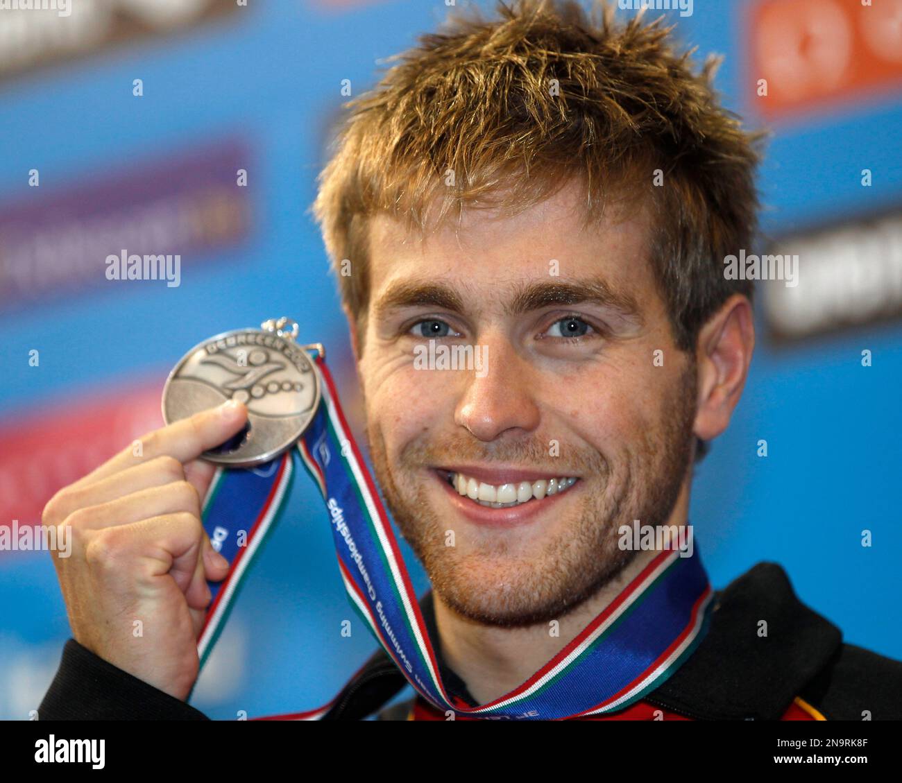 Germany's Helge Meeuw shows the silver medal he won in the Men's 100