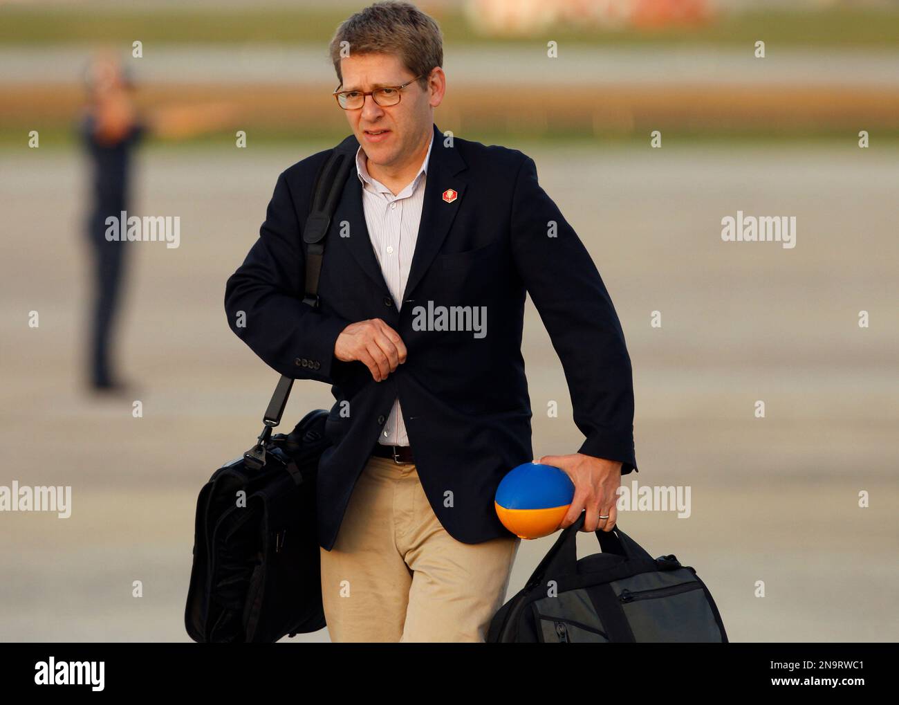 White House press secretary Jay Carney walks on the tarmac after ...
