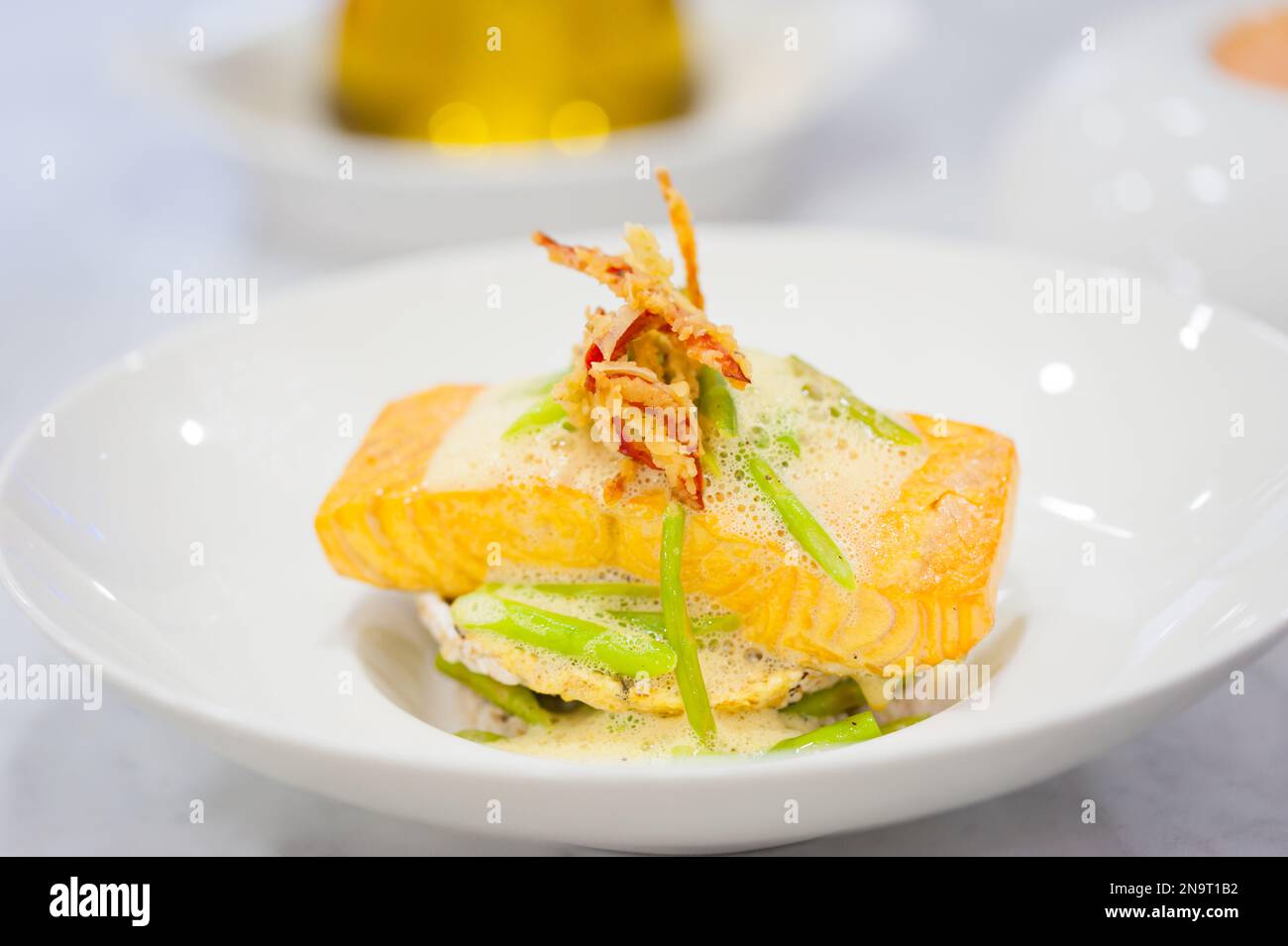 Closeup of salmon fillet with rice cakes, green beans, lemon butter