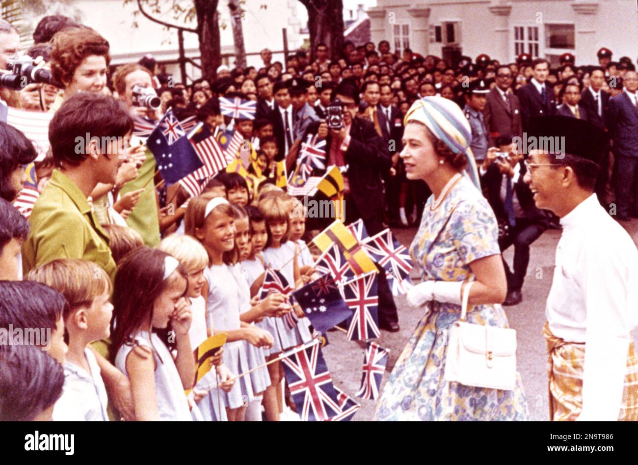 Britain's Queen Elizabeth II, continuing her tour of Asia, talks with