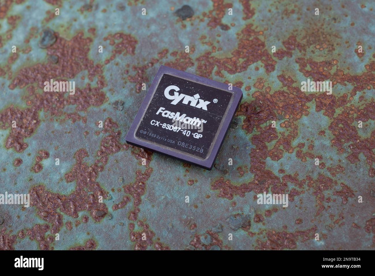 KYIV, UKRAINE - April 22, 2020. Cyrix FasMath 387 floating-point unit coprocessor unit on rusty metal background. Stock Photo