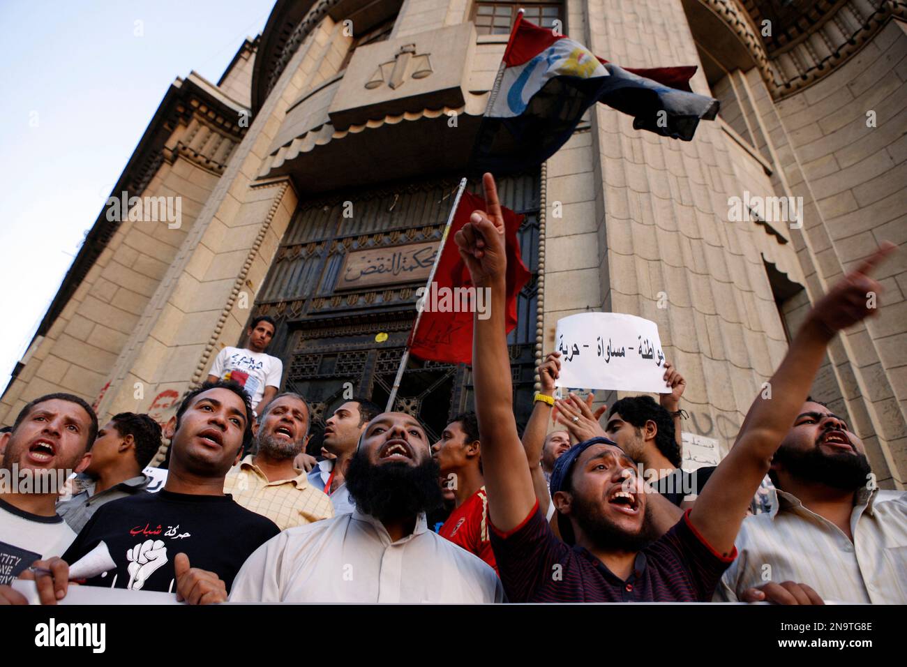 Egyptian men chant slogans during a demonstration demanding the release