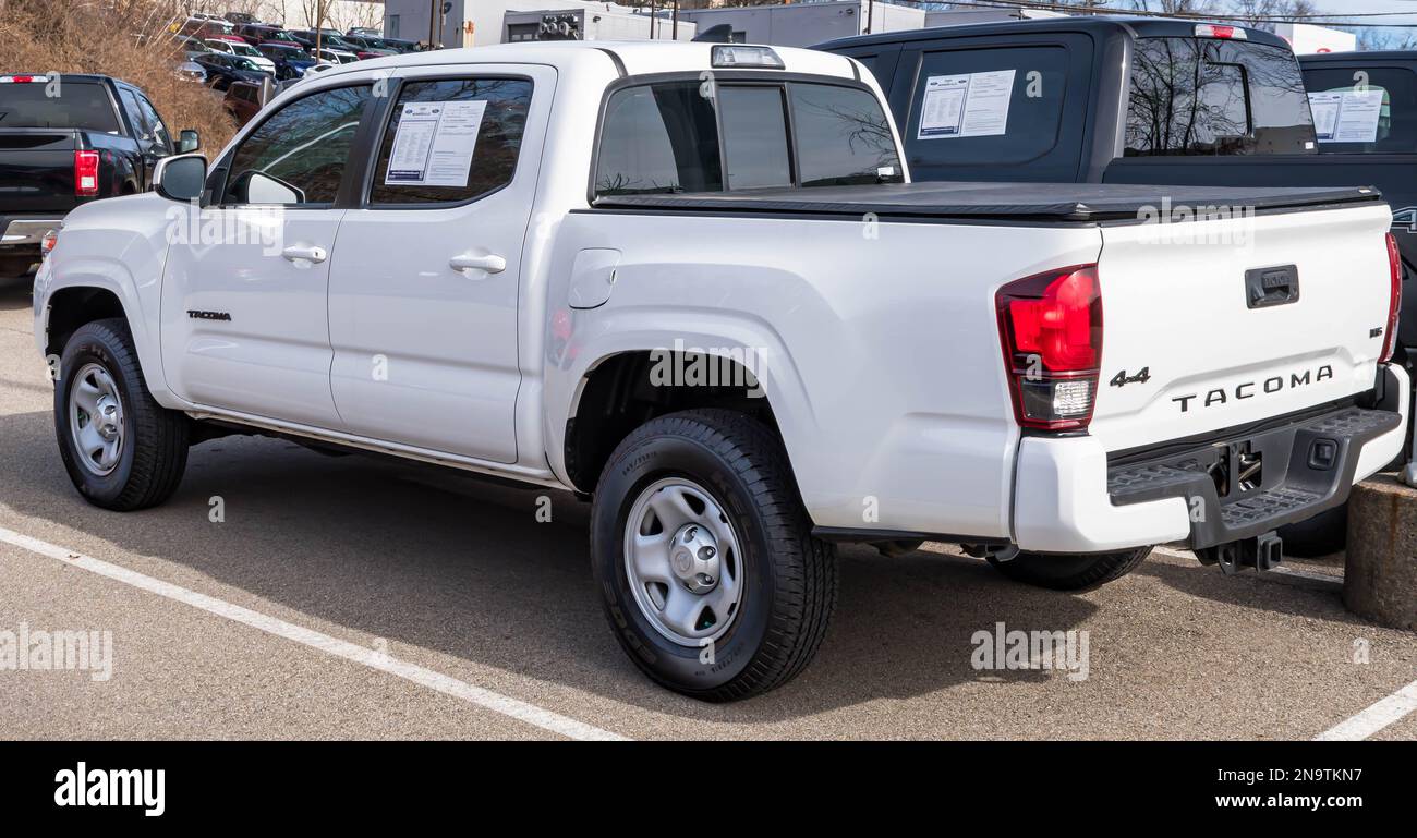 A used, white Toyota pickup truck for sale at a dealership in