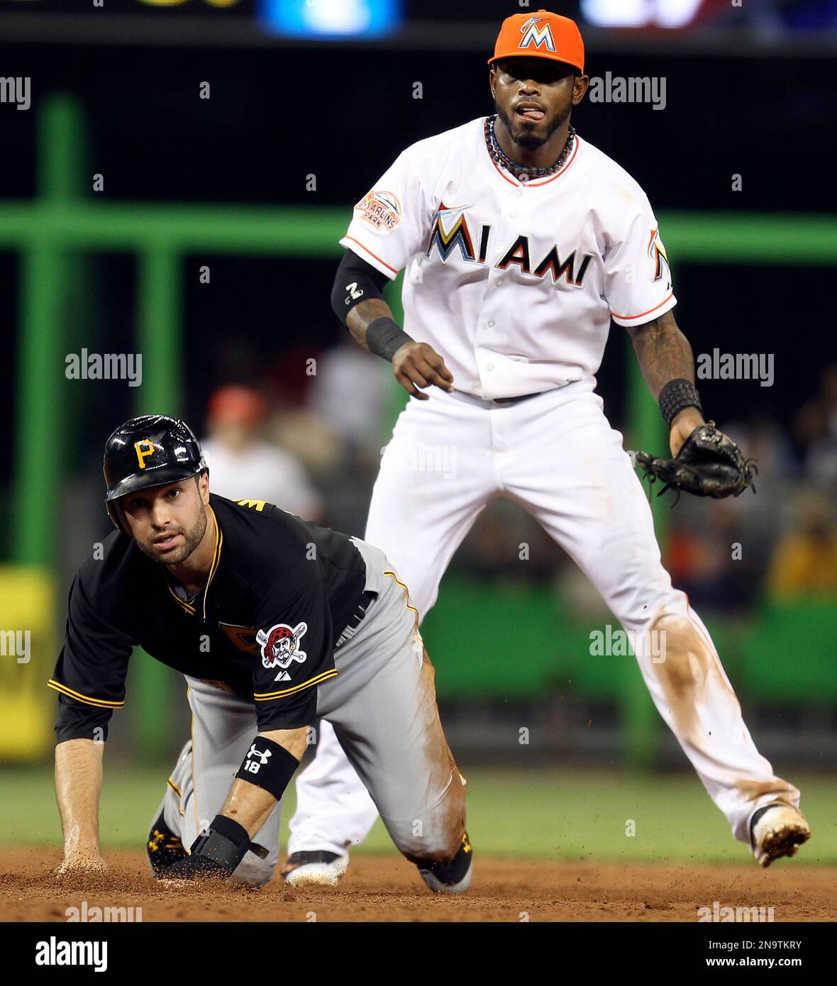 Miami Marlins shortstop Jose Reyes, right, and Pittsburgh Pirates' Neil  Walker wait to see if Pirates' Andrew McCutchen is out at first during a  third-inning double play in a baseball game in