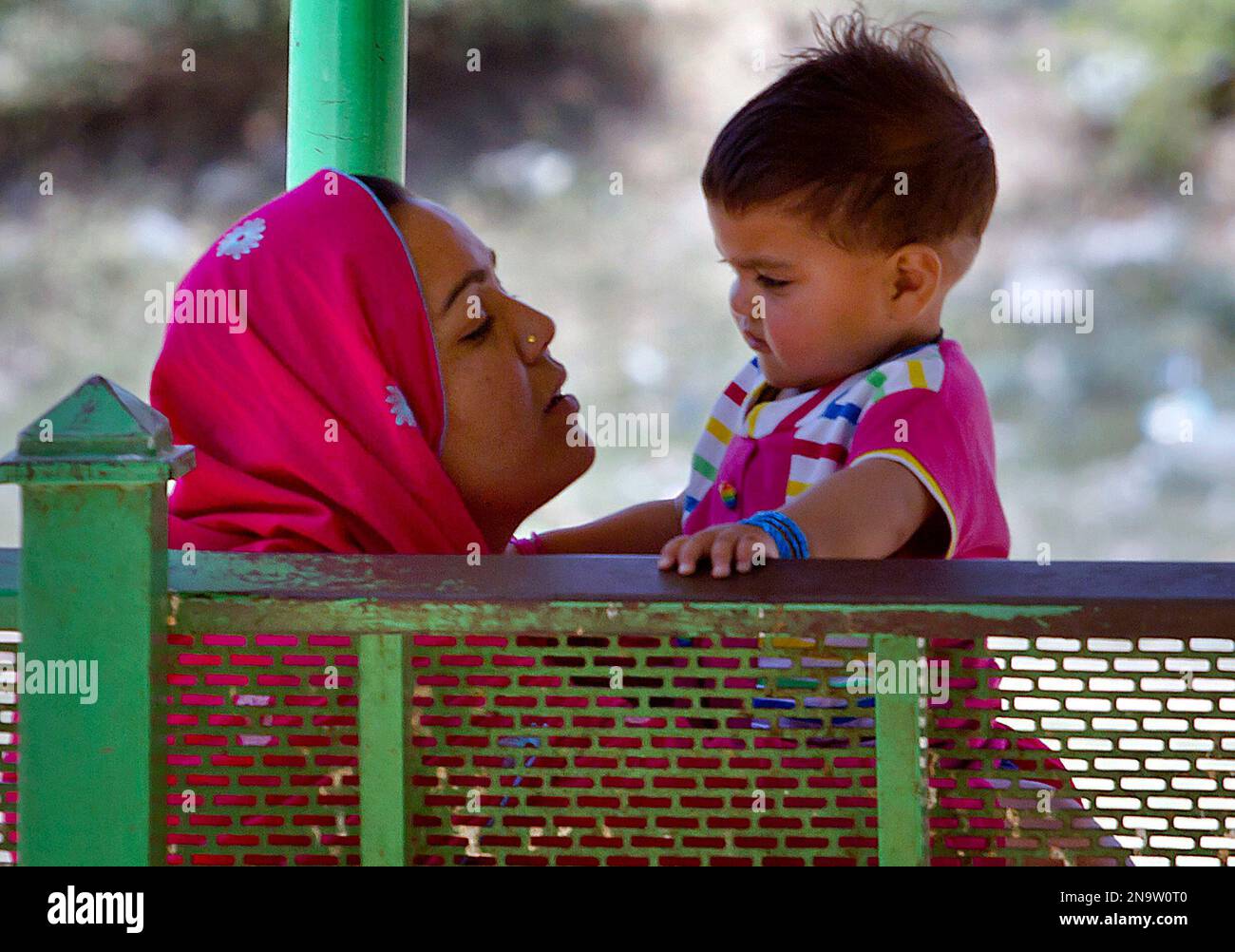 A Pakistani mother plays with her baby girl at a park on Mother's day ...