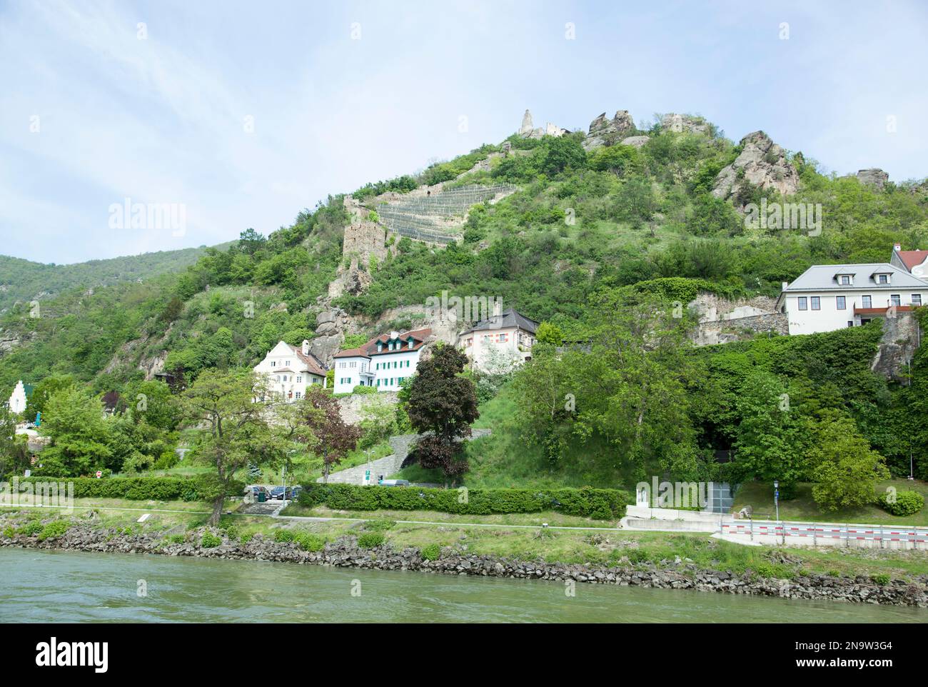 The springtime view of historic Durnstein town by Danube River with a ...