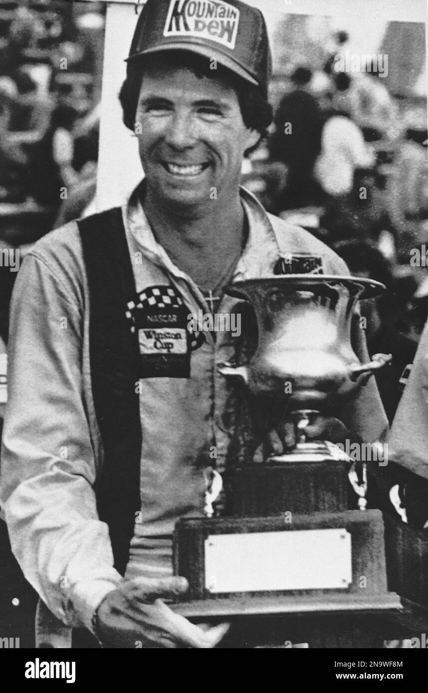 Darrell Waltrip of Franklin, Tenn., holds the winner's trophy after he won the NASCAR Pocono 500