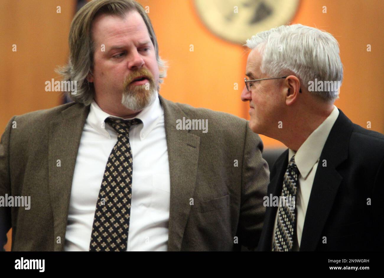 Defense attorney Travis Currie, left, talks to Steve Powell of the ...